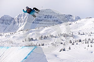 Snowboarder spinning doing a grab in the air