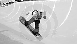 Snowboarder Spinning into the pipe in B/W half-pipe competition, Mammoth Mountain, California USA