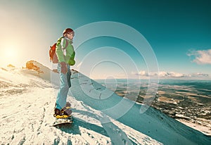 Snowboarder stay on the mountain top