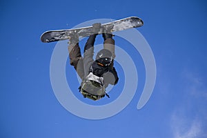 Snowboarder taking big air jump photo
