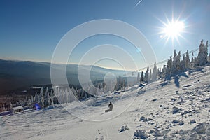 Snowboarder on white piste