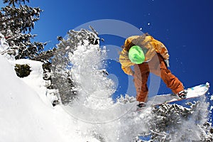 Snowboarders jumping against blue sky