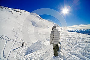 Snowboarders making jump