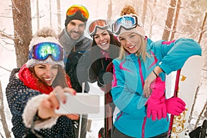 Snowboarders or skiers making selfie in fog forest