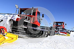 Snowboarders and skiers on ratrak