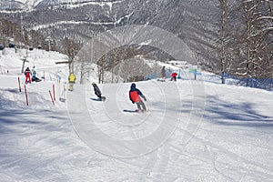 Snowboarders on a snowy slope.