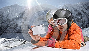 Snowboarders taking selfie