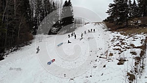 Snowboarding jibbing. Snowboarders perform tricks on the figures of jibbing. Aerial view. A snowboarder rides through a