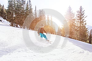 Snowboarding in winter Alps, man with fast speed on snowboard