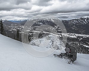 Snowborder Slashing Snow on Piste