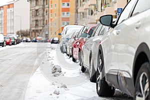 Snowbound cars parked at the roadside