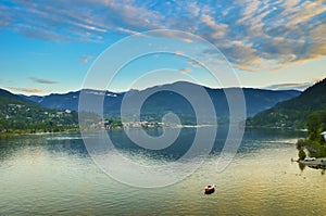 Snowcapped mountains overlooking calm lake at sunset