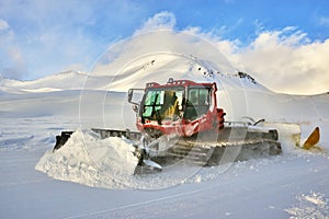 Snowcat rides to work in the evening