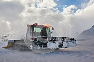 Snowcat rides to work in the evening