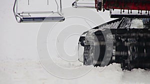 Snowcat works on a mountain slope at the ski