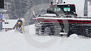 Snowcat works on a mountain slope at the ski