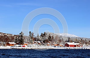 Snowcovered Cabins at the Fjord