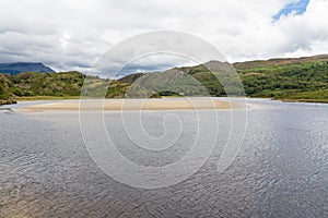 Snowdonia, River Dwyryd, sandbank, rocky hills and trees.