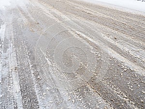 Snowdrifts on the side of the road. Bad weather and traffic. Snow on asphalt. Difficult driving conditions. Winter slosh