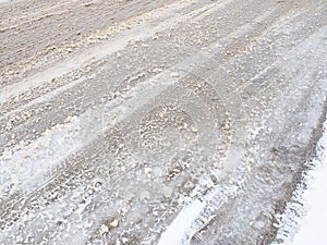 Snowdrifts on the side of the road. Bad weather and traffic. Snow on asphalt. Difficult driving conditions. Winter slosh