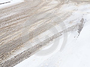 Snowdrifts on the side of the road. Bad weather and traffic. Snow on asphalt. Difficult driving conditions. Winter slosh