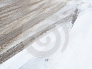 Snowdrifts on the side of the road. Bad weather and traffic. Snow on asphalt. Difficult driving conditions. Winter slosh