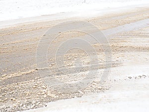 Snowdrifts on the side of the road. Bad weather and traffic. Snow on asphalt. Difficult driving conditions. Winter slosh