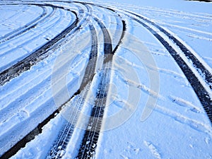 Snowdrifts on the side of the road. Bad weather and traffic. Snow on asphalt. Difficult driving conditions. Winter slosh