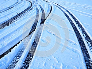 Snowdrifts on the side of the road. Bad weather and traffic. Snow on asphalt. Difficult driving conditions. Winter slosh