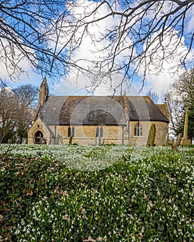 Snowdrops in front of a small English church.