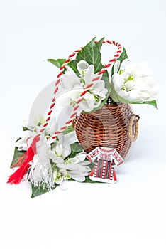 Snowdrops and red and white string martisor on white with copy space east european first of march tradition celebration