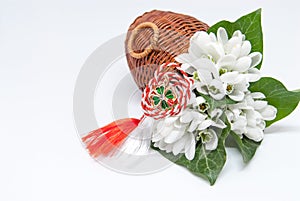 Snowdrops and red and white string martisor on white with copy space east european first of march tradition celebration