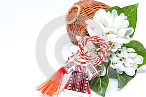 Snowdrops and red and white string martisor on white with copy space east european first of march tradition celebration