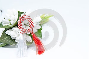 Snowdrops and red and white string martisor on white with copy space east european first of march tradition celebration