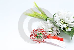 Snowdrops and red and white string martisor on white with copy space east european first of march tradition celebration