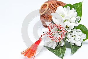 Snowdrops and red and white string martisor on white with copy space east european first of march tradition celebration