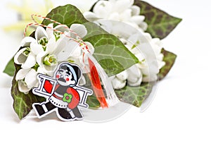 Snowdrops and red and white string martisor on white with copy space east european first of march tradition celebration