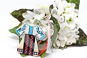 Snowdrops and red and white string martisor on white with copy space east european first of march tradition celebration