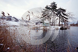 Snowed landscape on lake saint andre, savoy, france