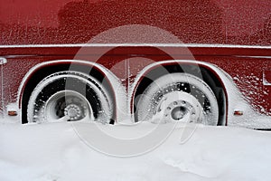 Snowed In Tires Of A Darkred Buss