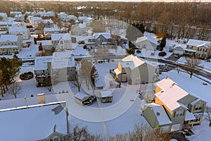 After a snowfall, an American town home complex is near a small river residential street in a snowy winter landscape