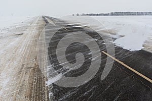 Snowfall and blizzard sweep the road