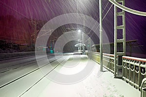 Snowfall on a deserted railway station