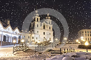 Snowfall in Minsk at winter night, Belarus. New Year and Christmas time in Minsk city. Cityscape of snowy Minsk