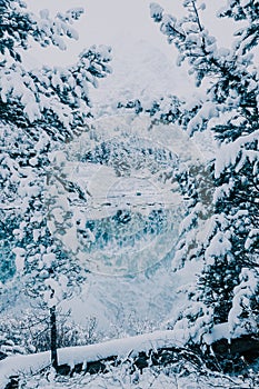 Snowfall on the mountain lake