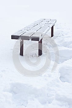 After snowfall and rain bench all has iced over