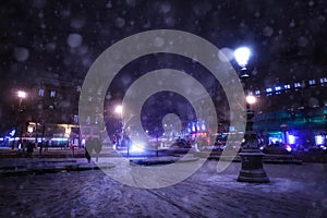 Snowfall on Republique square in Paris at night