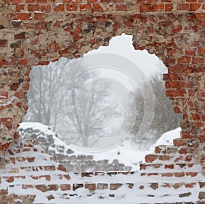 Snowfall in Ruins of the Viljandi Order Castle. A view through opening in the wall