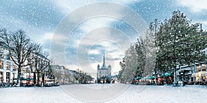 Snowfall in winter at the central historic square in the ancient city center of Deventer, The Netherlands