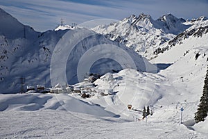 Snowfield and snow covered high alpine mountain peaks